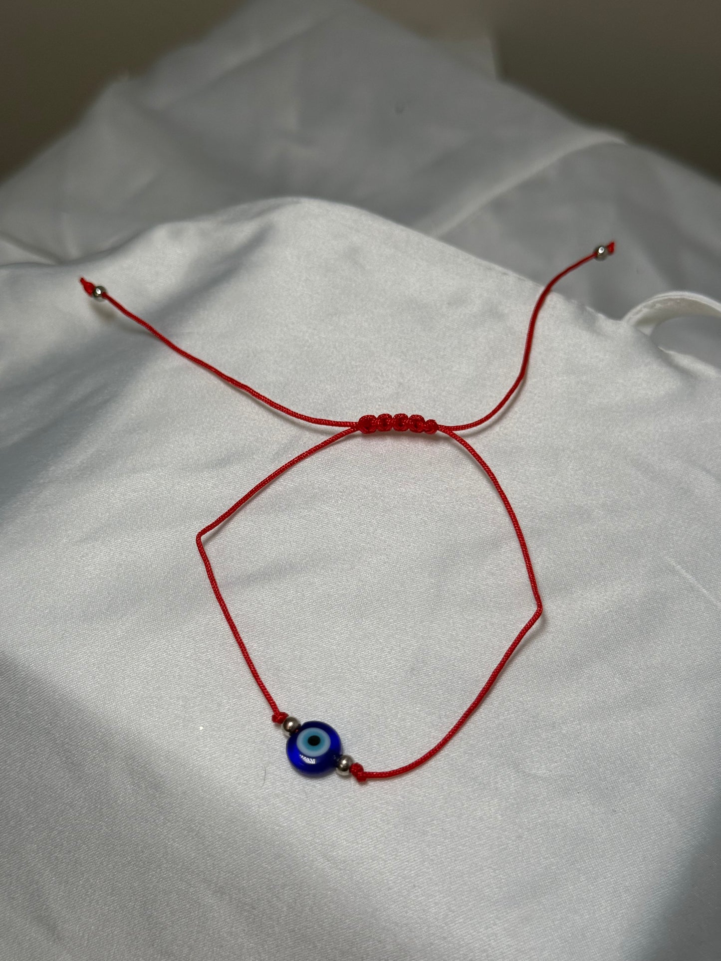 JJ’s Red evil eye string bracelet
