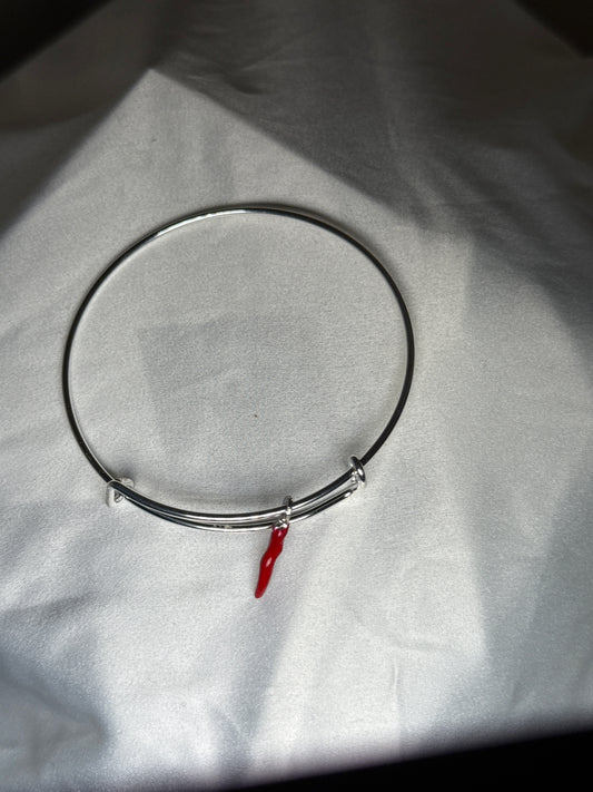 Silver bangle with red horn