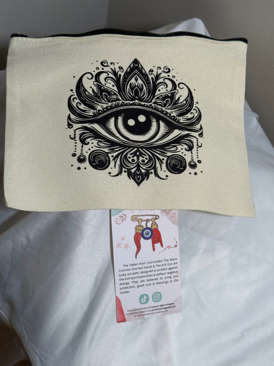 Black evil eye on natural colored canvas make up bag