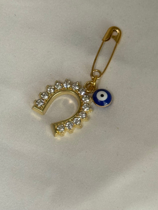 Garment pin with evil eye and horseshoe in rhinestones