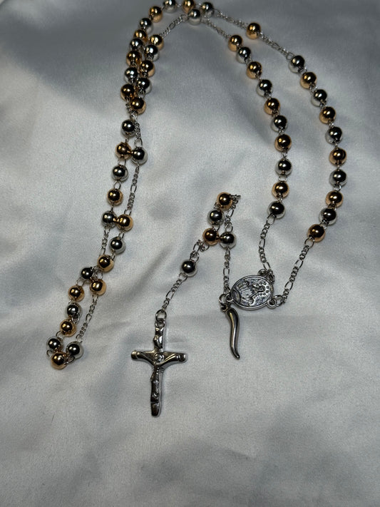 Gold and silver colored rosary bead featuring the Italian horn