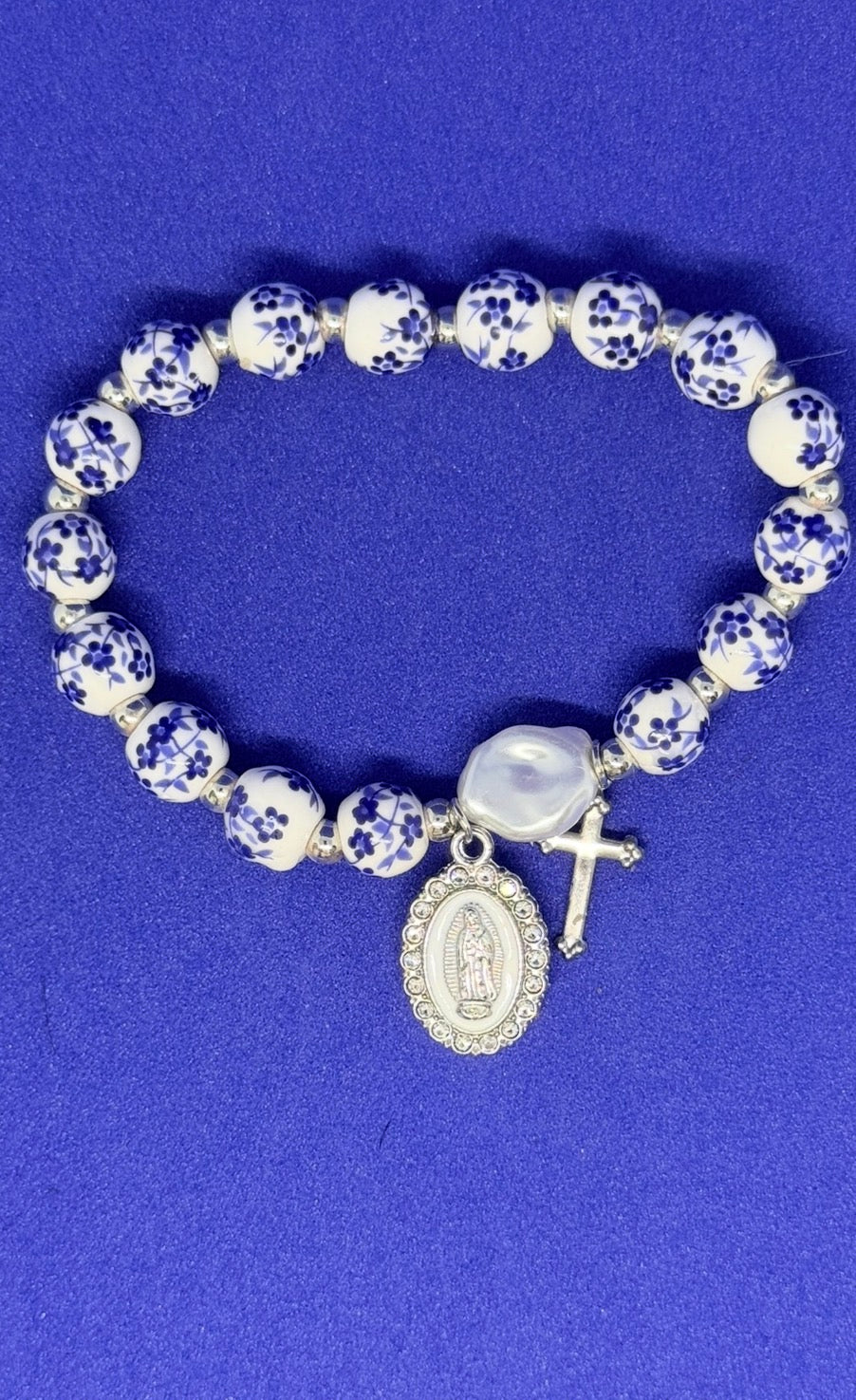 Blue and white floral ceramic beaded bracelet with blessed mother and cross